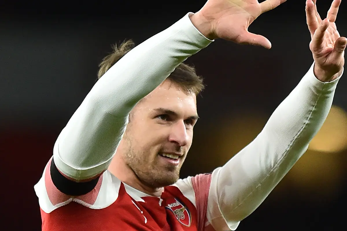 Gelandang Arsenal, Aaron Ramsey, merayakan gol yang dicetaknya ke gawang Fulham pada laga Premier League di Stadion Emirates, London, Selasa (1/1). Arsenal menang 5-1 atas Fulham. (AFP/Glyn Kirk)