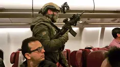 Polisi bersenjata lengkap berjalan di dalam pesawat Malaysia Airlines Flight MH128 untuk menangkap seorang pria Sri Lanka setelah penerbangan tersebut melakukan pendaratan darurat di Melbourne, Australia (1/6). (Andrew Leconcelli via AP)
