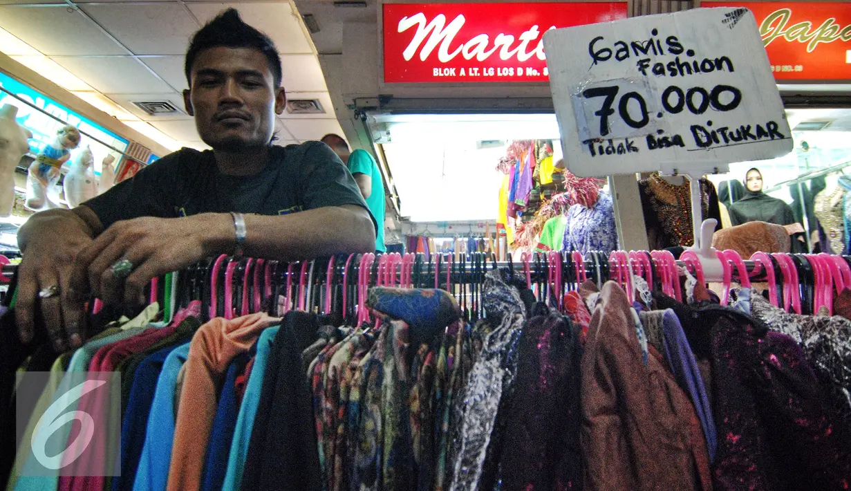 Seorang penjual tampak bergaya di dekat barang dagangannya di Pasar Tanah Abang, Jakarta, Kamis (2/7/2015). Memasuki pertengahan Ramadan pedagang mengaku penjualan baju muslim meningkat dari bulan-bulan sebelumnya. (Liputan6.com/Yoppy Renato)