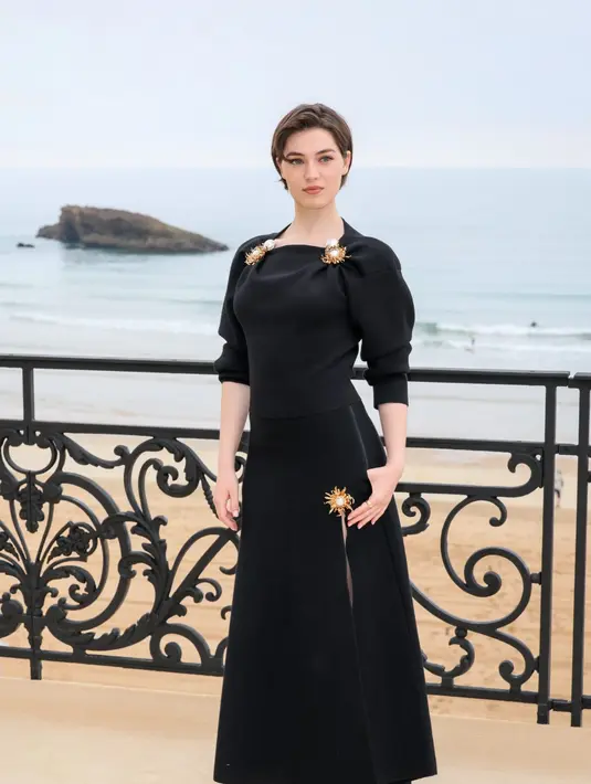  jaket suede beige dipadu kemeja merah bold dan celana tailored, dilengkapi tas Chanel pink statement yang playful sekaligus sentimental. [Dok/Chanel].