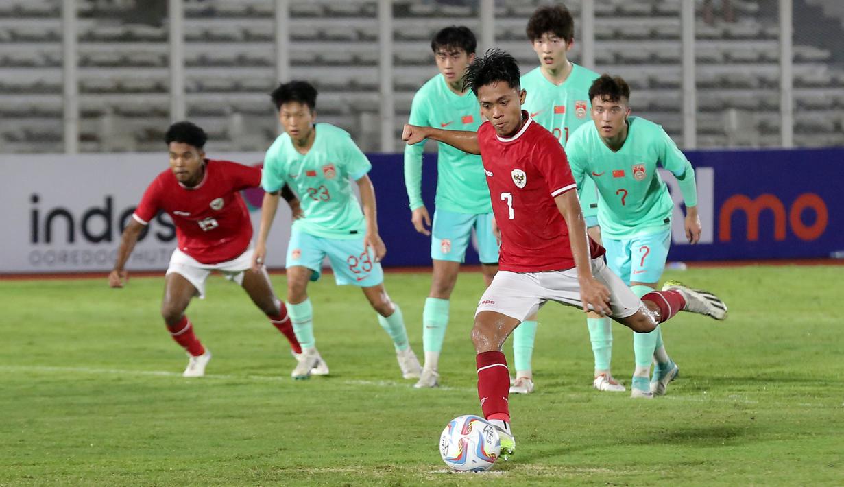 Pemain Timnas Indonesia, Figo Dennis mencetak gol melalui tendangan penalti pada laga persahabatan melawan Timnas China U-20 di Stadion Madya, Senayan, Jakarta, Jumat (22/03/2024). (Bola.com/Abdul Aziz)