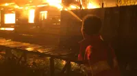 Petugas pemadam kebakaran berusaha memadamkan api yang terjadi di kawasan Rindang Banua atau lebih dikenal dengan Puntun, di Kecamatan Pahandut, Kota Palangkaraya. (foto: Roni Sahala)