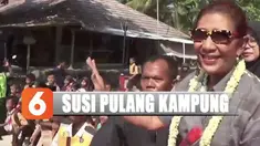 Saking banyaknya warga yang datang menyambut membuat Susi harus dikawal menuju mobil yang telah disiapkan.