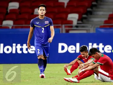 Pemain timnas Indonesia U-23, Ahmad Nufiandani dan Syaiful Indra Cahya terduduk usai dikalahkan Thailand dalam semifinal sepak bola SEA Games ke-28 di National Stadium Singapore, Sabtu (13/6/2015). Indonesia kalah 0-5. (Liputan6.com/Helmi Fithriansyah)