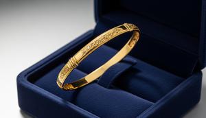 Tren Gelang Emas Bangle Tipis 2026 untuk Ibu Usia 50 Tahun yang Suka Tampilan Rapi Model Emas Kuning dengan Ukiran Kaligrafi Personal/ Ilustrasi AI