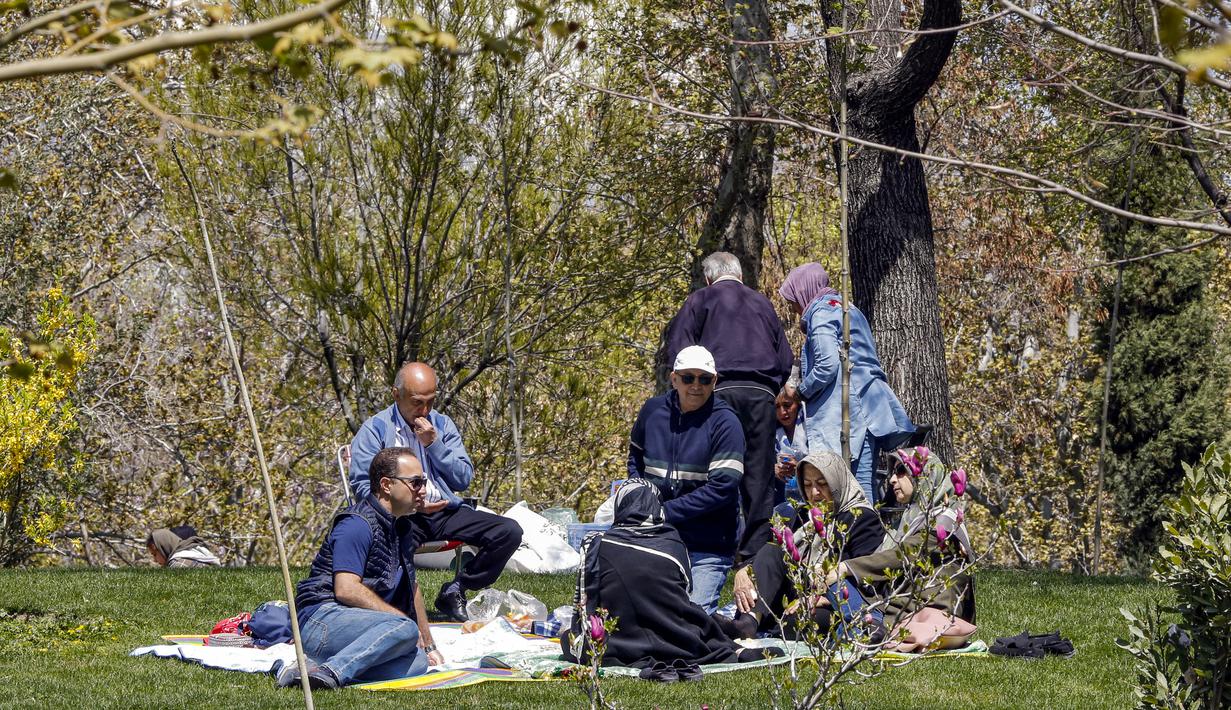 Dianggap tidak beruntung jika tinggal di rumah pada hari itu, sehingga taman dan kebun dipenuhi oleh keluarga, tua dan muda, yang menghabiskan hari di luar ruangan. (Photo by AFP)