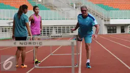 Pelatih Harry W Marra (kanan) memberi contoh latihan pada atlet lompat gawang Indonesia di Stadion Pakansari, Kab Bogor, Selasa (14/2). Rencananya Harry akan memberikan pelatihan singkat delapan dasa lomba atletik. (Liputan6.com/Helmi Fithriansyah)