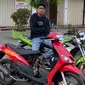 Mirza sedang menunggangi Kawasaki Ninja 150 R sembari menunjukkan Mio Sporty Merah hasil modifikasi andalannya. (Sumber: Instagram/@mirzanrhmn)