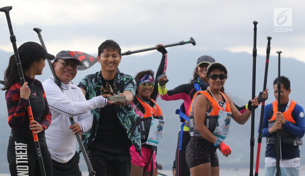 Dirut BPJS Ketenagakerjaan, Agus Susanto menyerahkan secara simbolis terumbu karang ke Bupati Trenggalek, Mochammad Nur Arifin di Pantai Mutiara, Trenggalek, Jawa Timur, Sabtu (7/9/2019). BPJS Ketenagakerjaan memberikan bantuan 100 terumbu karang. (Liputan6.com/Herman Zakharia)