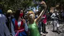 <p>Penggemar anime dan video game Kuba berpakaian seperti pahlawan atau karakter favorit mereka, berpose untuk selfie selama parade Cosplay di sela-sela Pameran Buku Internasional Havana, di Havana, Sabtu (23/4/2022). (AP Photo/ Ramon Espinosa)</p>