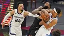 Pebasket Memphis Grizzlies, Dillon Brooks dan Brandon Clarke, berusaha merebut bola dari pebasket Cleveland Cavaliers, Andre Drummond, pada laga NBA, Senin (11/1/2021). Grizzlies menang dengan skor 101-91. (AP/Tony Dejak)