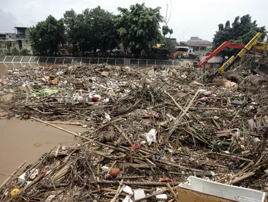Penampakan tumpukan sampah yang menggunung di Jembatan Jalan KH Abdullah Syafei, Jakarta, Selasa (6/2). Puluhan truk sampah dikerahkan petugas untuk mengangkut sampah tersebut. (Liputan6.com/Arya Manggala)