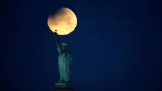 Pemandangan ketika Patung Liberty dihiasi oleh supermoon di Brooklyn, New York, Amerika Serikat, Rabu (31/1). Supermoon adalah di mana bulan berada pada jarak terdekatnya dengan bumi. (AP Photo/Julio Cortez)