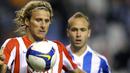 Deportivo Coruna's Laure vies with Atletico Madrid's Uruguayan Diego Forlan during their Spanish first league match at the Riazor Stadium in La Coruna, on April 12, 2009. AFP PHOTO/MIGUEL RIOPA