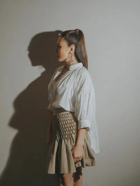Kemeja ini dipadukan dengan rok mini pleated berwarna khaki seharga Rp56jutaan [@wulanguritno]