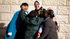 Seorang guru dengan Down Syndrome yang bernama Hiba Al-Sharfa bermain dengan muridnya di sekolah Asosiasi Hak Hidup di Kota Gaza (21/12). Hiba adalah seorang guru yang memeliki “kebutuhan khusus” di Jalur Gaza. (Reuters/Suhaib Salem)