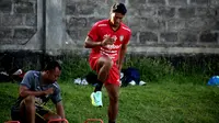 Bek kanan Bali United, I Made Andhika Wijaya, masih berlatih terpisah dengan fisioterapi di Lapangan Gelora Trisakti Legian pasca operasi di bagian engkel dua bulan lalu. (Bola.com/Maheswara Putra)