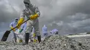 Tentara Angkatan Laut Sri Lanka menyingkirkan puing-puing dari kapal kontainer MV X-Press Pearl yang terdampar di sebuah pantai di Kolombo, Jumat (28/5/2021). Akibat kebakaran tersebut, limbah dari kapal mencemari laut Sri Lanka hingga terdampar ke pinggir pantai.  (Ishara S. KODIKARA/AFP)