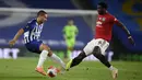 Pemain Manchester United Paul Pogba (kanan) mencoba menghentikan pemain Brighton Neal Maupay pada pertandingan Premier League di Stadion AMEX, Brighton, Inggris, Selasa (30/6/2020). Manchester United menang 3-0 dengan dua gol dicetak Bruno Fernandes. (Mike Hewitt/Pool via AP)