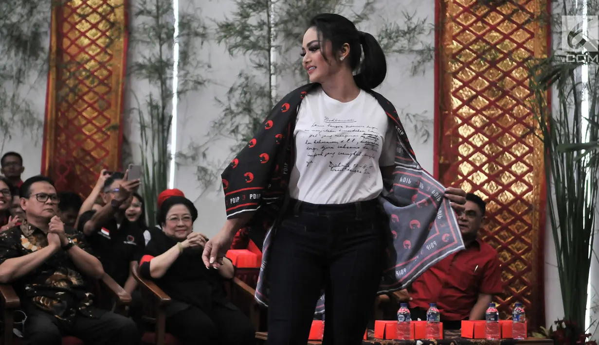 Penyanyi Krisdayanti yang merupakan kader PDIP saat memperagakan Atribut Milenial di Kantor DPP PDIP, Jakarta, Kamis (20/9). Peluncuran Atribut Milenial untuk kampanye Pemilu 2019 ini diperagakan langsung oleh para kader. (Merdeka.com/ Iqbal S. Nugroho)