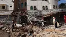 Orang-orang memeriksa dampak dari serangan Israel di Khan Yunis, Jalur Gaza Selatan pada 14 Mei 2025. (Eyad BABA/AFP)