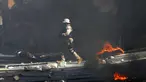 Polisi membersihkan jalan dari batu dan ban yang dibakar oleh pengunjuk rasa yang marah dengan meningkatnya kekerasan di lingkungan Lalue, Port-au-Prince, Haiti, Rabu (14/7/2021). Presiden Haiti Jovenel Moise dibunuh pada 7 Juli. (AP Photo/Fernando Llano)