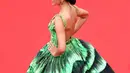 Beginilah gaya Raline Shah saat hadiri acara bergengsi dunia di red carpet Cannes 2022, Prancis. Tampak rambut yang disanggul memamerkan bahu dan punggungnya. Ia memakai gaun hijau glow in the dark rancangan Michael Cinco.