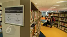 Untuk menambah wawasan tentang dunia olahraga, sebuah perpustakaan ‘Sport Library’ disediakan di areal National Stadium Singapura. Tampak, beberapa pengunjung memilih buku yang akan dibacanya, Senin (1/6/2015). (Liputan6.com/Helmi Fithriansyah)