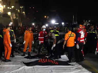 Personil SAR Gabungan bersiap mengindetifikasi kantong jenasah yang diturunkan dari KN SAR Sadewa di Pelabuhan JICT 2, Jakarta, Rabu (31/10). 189 orang menjadi korban jatuhnya pesawat Lion Air JT-610, Senin (29/10) lalu. (Liputan6.com/Helmi Fithriansyah)