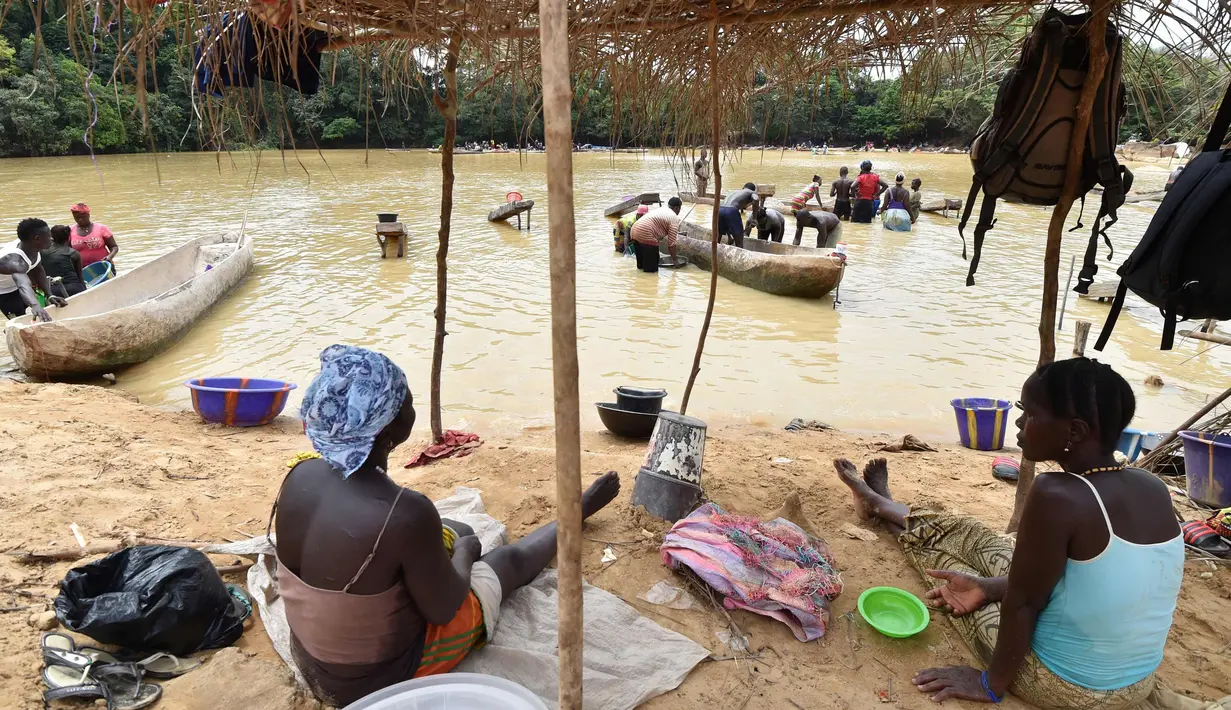 Penambang emas wanita berisitirahat di sungai Pampana di dekat Mekeni, sebelah utara Sierra Leone (5/3). Melintasi tanah yang curam, ratusan pria dan wanita di sungai menyaring kerikil, memisahkan bintik-bintik emas dari lumpur. (AFP Photo/Issouf Sanogo)