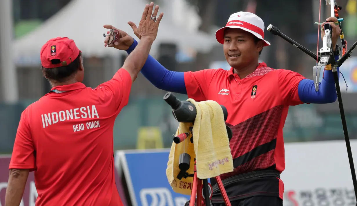 Ekspresi pemanah putra Indonesia, Riau Ega Agata Salsabilla (kanan) usai mengalahkan Ilfat Abdullin asal Kazakhstan di Asian Games 2018, di Jakarta, Selasa (28/8). Riau Ega memperoleh medali perunggu. (AP Photo/Lee Jin-man)