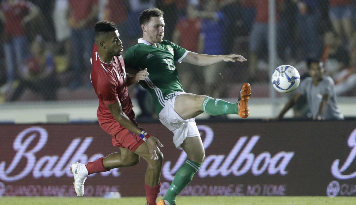 Pemain Irlandia Utara, Corry Evans (kanan) menghalau bola dari kejaran pemain Panama, Anibal Godoy pada laga uji coba di Panama City, (29/5/2018). Panama dan Irlandia Utara bermain imbang 0-0. (AP/Arnulfo Franco)