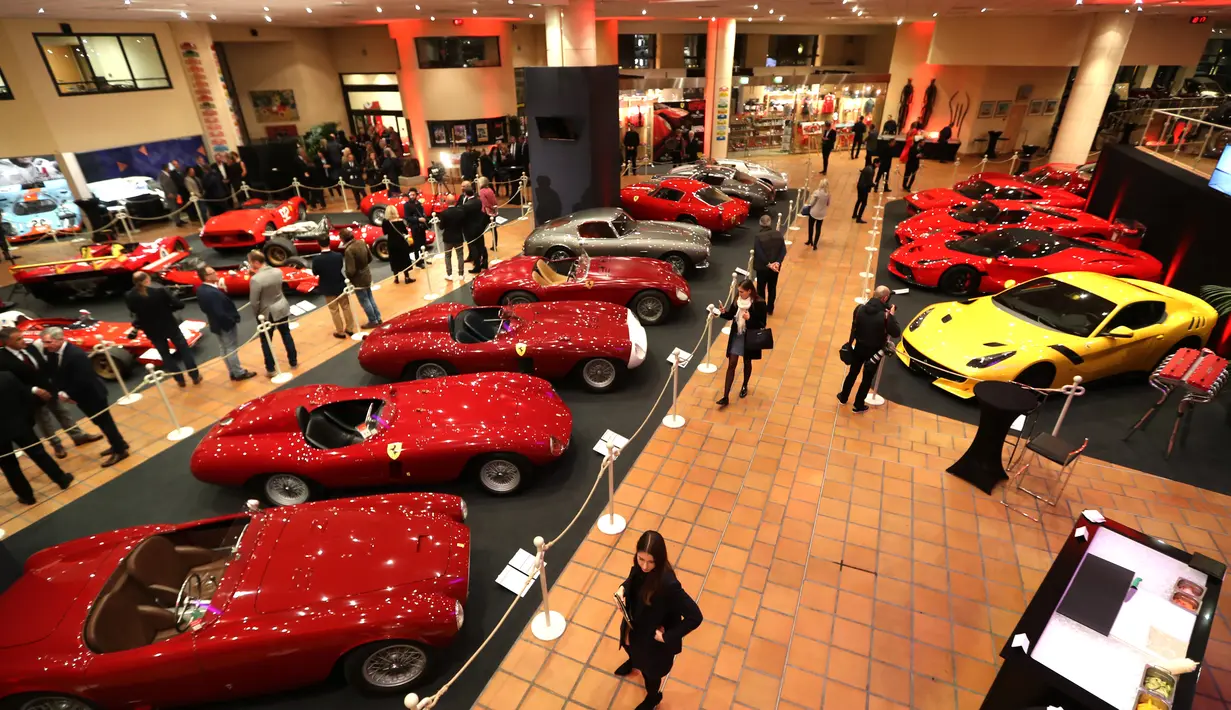 Pengunjung melihat mobil Ferrari klasik saat dipamerkan dalam peresmian pameran Ferrari di Monako (3/12). Sekitar lima puluh mobil ferrari unik klasik di dunia ini dipamerkan di acara tersebut. (AFP Photo/Valery Hache)