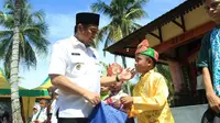 Bupati Bone Bolango, Hamim Pou bersama salah satu Anak Yatim (Arfandi Ibrahim/Liputan6.com)