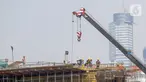 Pekerja menyelesaikan proyek pembangunan Light Rail Transit (LRT) Jabodebek di ruas Jalan Rasuna Said, Jakarta, Jumat (7/8/2020). Salah satu proyek PT Adhi Karya, LRT Jabodebek, ditargetkan selesai pada Juni 2022 di tengah pandemi COVID-19. (Liputan6.com/Fery Pradolo)