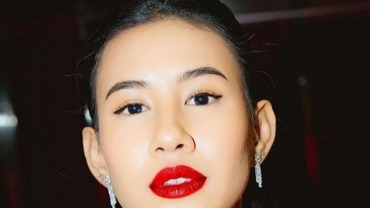 Shenina tampil berani dalam balutan dress kecokelatan tanpa lengan, dipadukan dengan kalung simpel namun mewah, serta tatanan rambut dicepol rapi ke belakang yang memperkuat makeup simpel nan menawan.<br><br>
