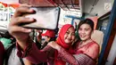 Pengemudi ojek online wanita berswafoto jelang peragaan busana di Rawamangun, Jakarta, Jumat (20/4). Kegiatan digelar menyambut Hari Kartini yang jatuh pada 21 April mendatang. (Liputan6.com/Fery Pradolo)