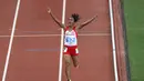 Ekspresi pelari putri Indonesia, Triyaningsih, setelah meraih emas nomor lari 5.000m SEA Games 2015. (Bola.com/Arief Bagus)