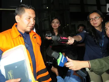 Bupati Bener Meriah Ahmadi dikawal petugas usai menjalani pemeriksaan perdana pasca ditahan OTT di Gedung KPK, Jakarta, Rabu (18/7). Ahmadi diperiksa terkait dugaan suap dana otonomi khusus Aceh tahun anggaran 2018. (Merdeka.com/Dwi Narwoko)