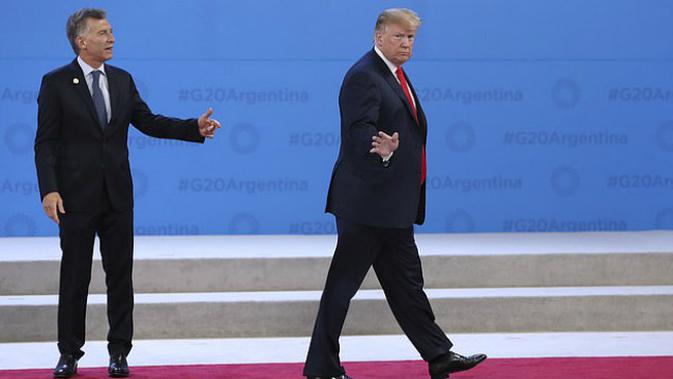 Presiden AS Donald Trump (kanan) meninggalkan Presiden Argentina Mauricio Macri di panggung foto bersama KTT G20 (1/12) (AP PHOTO)