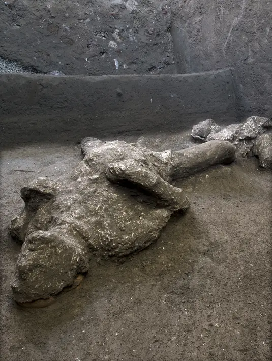 Salah satu dari dua jasad diyakini sebagai orang kaya dan budak prianya yang melarikan diri dari letusan gunung berapi Vesuvius hampir 2.000 tahun lalu, di pinggiran kota Romawi kuno Pompeii. Penemuan diumumkan otoritas arkeologi Italia pada Sabtu (21/11/2020). (Parco Archeologico di Pompei via AP)