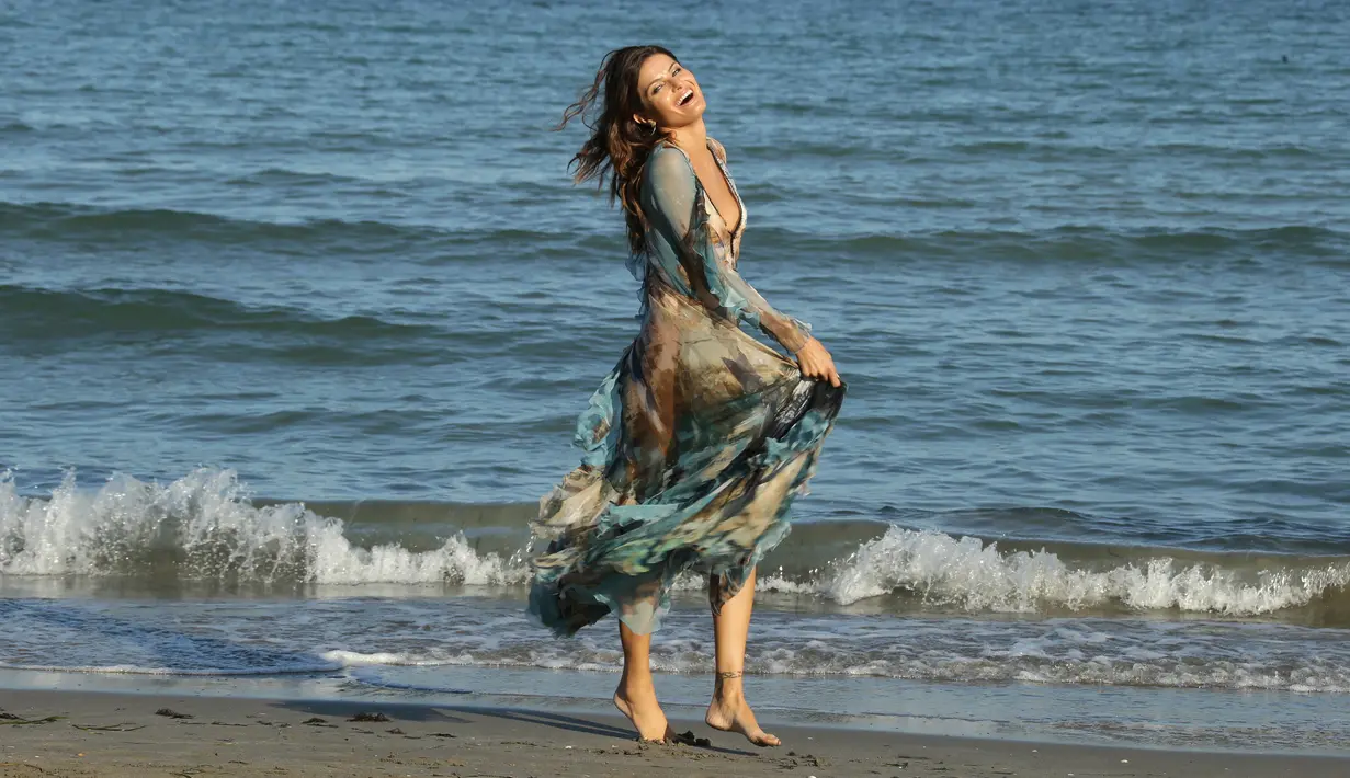 Model asal Brasil Isabeli Fontana saat bermain di pantai selama Festival film Venice ke-74 di Venice, Italia (30/8). Model seksi ini menjadi sorotan warga saat pemotretan di pantai tersebut. (Photo by Joel Ryan/Invision/AP)
