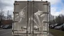 Sebuah truk kotor disulap menjadi lukisan ikan monster oleh Nikita Golubev di Moskow, Sabtu (22/4). Golubev menggunakan truk dan van yang kotor dan berdebu untuk menciptakan karya seninya. (AP Photo / Pavel Golovkin)