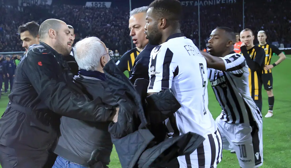 Presiden PAOK Ivan Savvidis memaki salah satu ofisial laga saat Liga Super Yunani kontra AEK Athens di Stadion Toumbas, Minggu (11/3). Ivan Savvidis memasuki lapangan dengan membawa senjata di pinggangnya. (InTime Sports via AP)