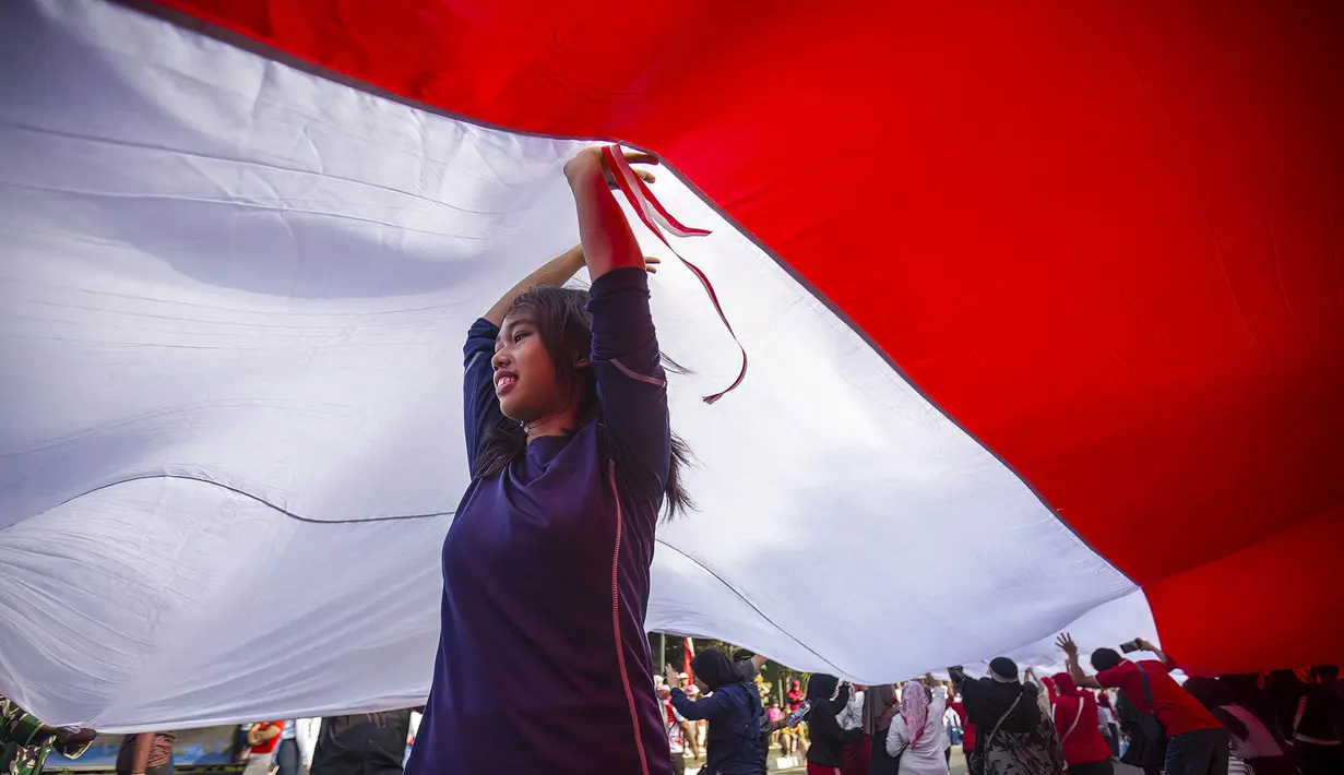 Warga berpartisipasi dalam pawai membawa bendera Indonesia sepanjang 500 meter di Jalan Sudirman Bogor, Jawa Barat, Minggu,  9 Agustus 2026. (AFP/ Aditya Aji)