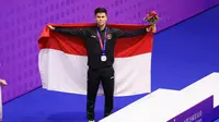 Edgar Xavier Marvello, atlet Indonesia cabang olahraga wushu, berhasil meraih medali perak saat tampil di XSG Sport Center, Minggu (24/9/2023). (NOC Indonesia / Naif Al&rsquo;as)