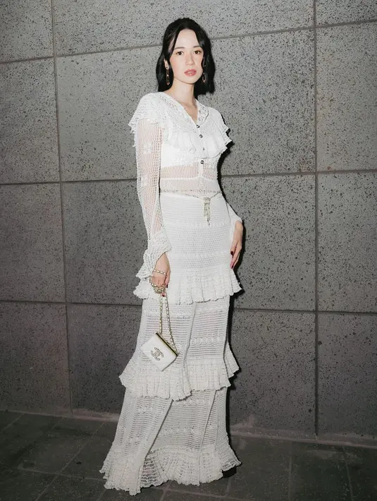 Salah satunya saat tampil dengan dress semi transparan serba putih dari Chanel. Gaun rajutan ini memiliki detail ruffle yang khas. [@laurabas]