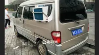 Seorang pemilik minivan memasangkan AC dinding di mobilnya (Foto: xinhuanet)
