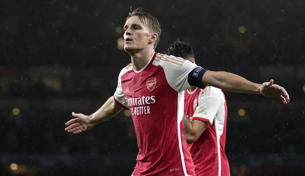 Pemain Arsenal, Martin Odegaard melakukan selebrasi setelah mencetak gol keempat timnya ke gawang PSV Eindhoven pada laga Grup B Liga Champions 2023/2024 di Emirates Stadium, London, Kamis (21/09/2023) dini hari WIB. (AP Photo/Kin Cheung)