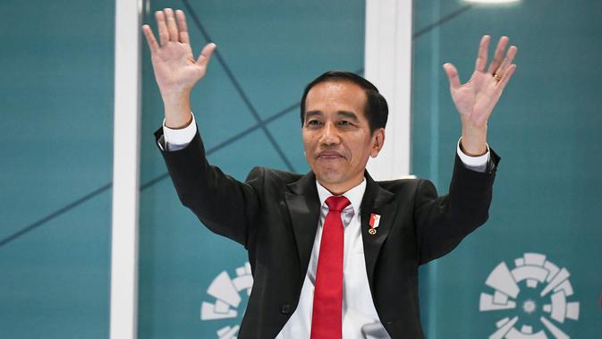 Presiden Republik Indonesia, Joko Widodo, menyapa penonton saat pembukaan Asian Games 2018, Sabtu (18/8/2018). (AFP/Jewel Samad)